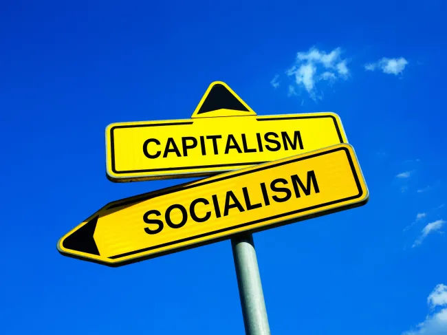 road signs with socialism and capitalism
